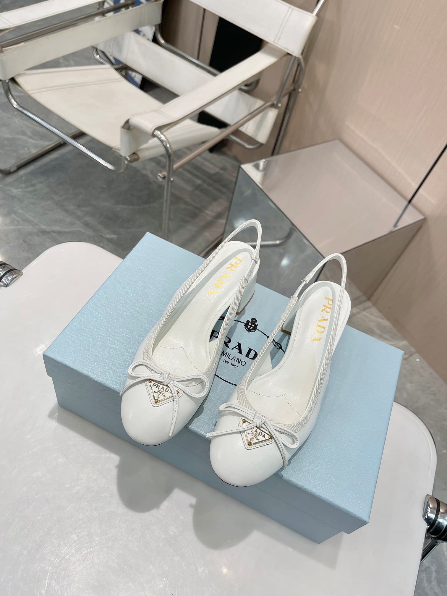Pra*a Triangle Logo Bow Slingback Pump In White