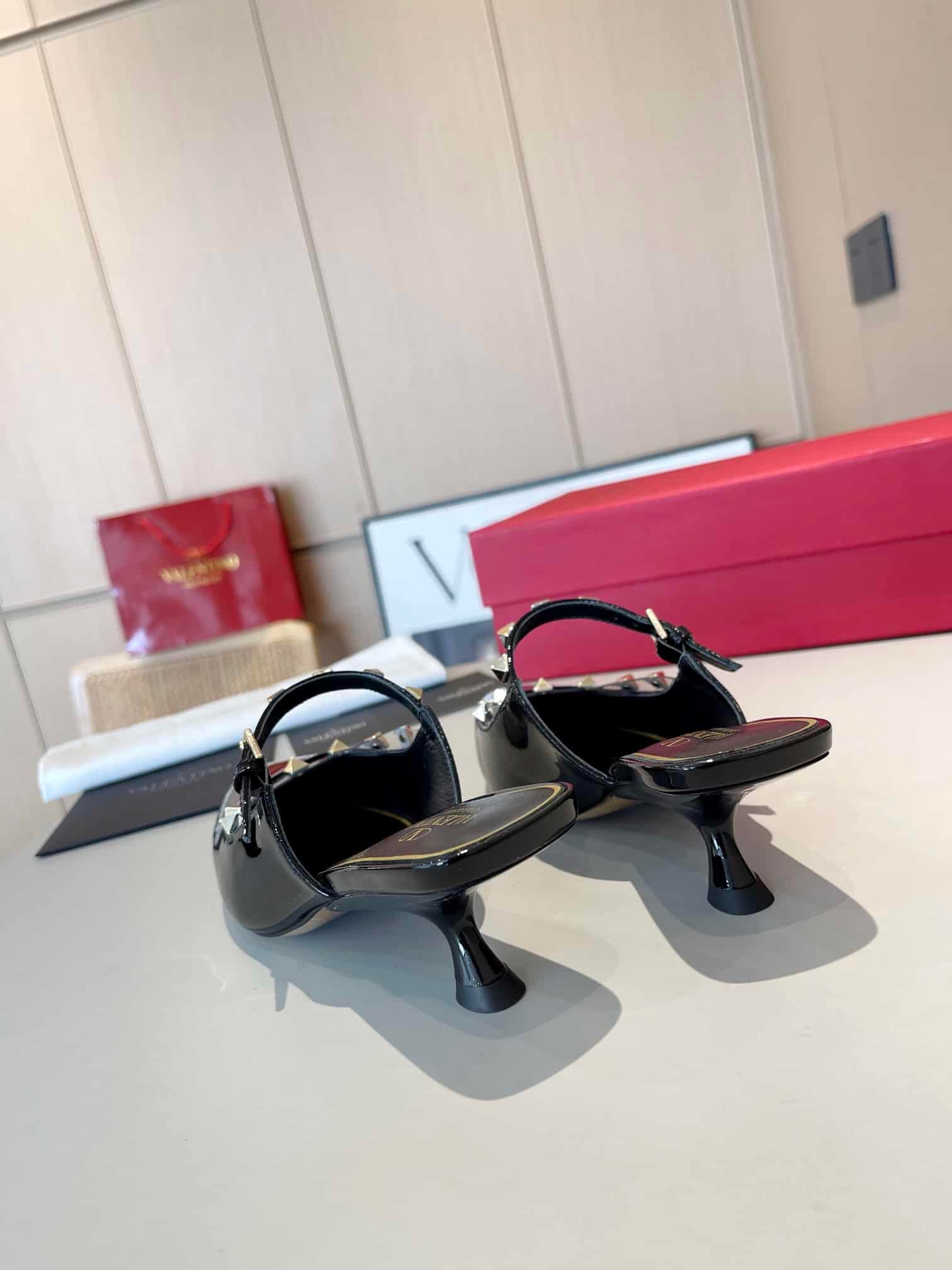 Va1e*ntin0 Garavani Rockstud Asymmetric Patent Leather Mules Black